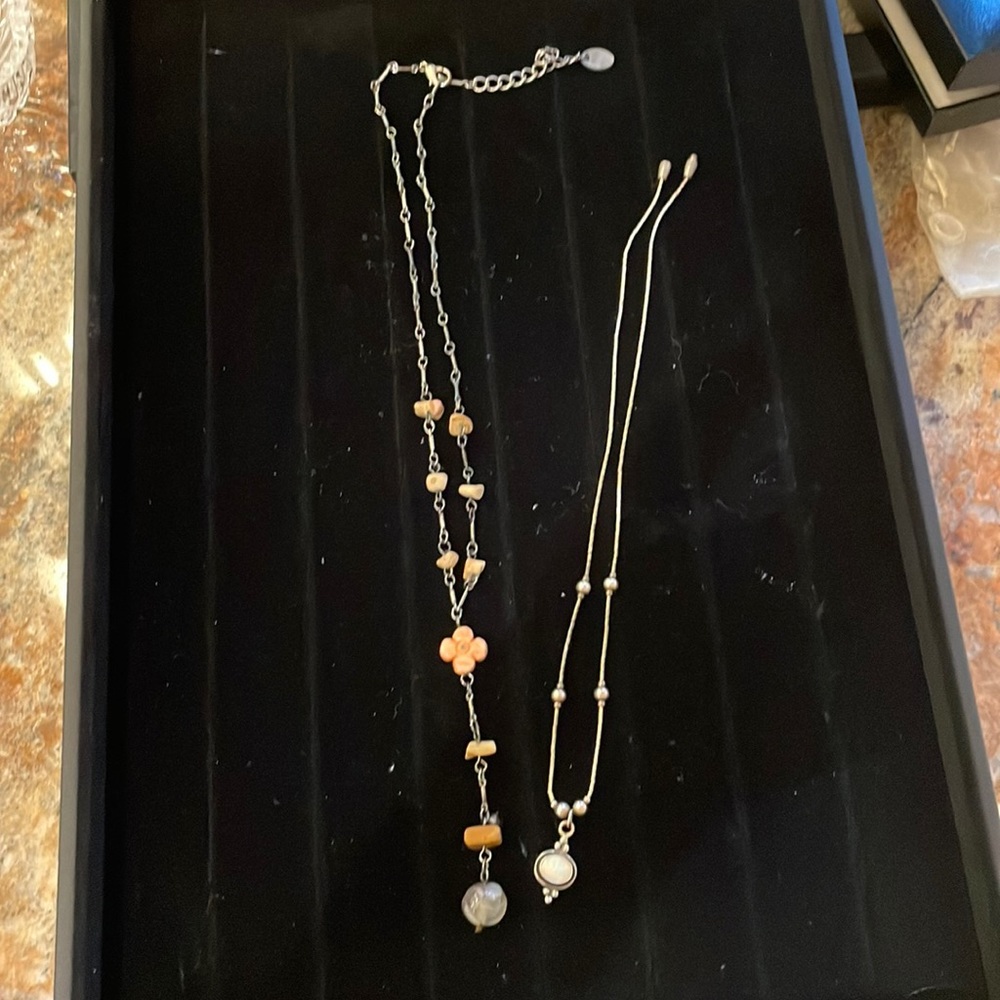 Two necklaces. One sterling and the other costume jewelry. Very fashionable
